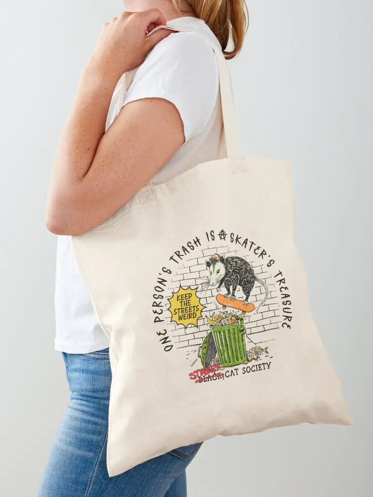 A sturdy canvas tote bag featuring the Street Cat Society skateboarding opossum design, ideal for an urban "trash cat" aesthetic and daily errands.