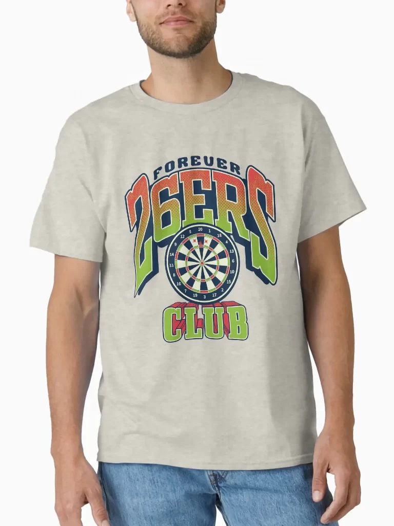 A man in a heather grey t-shirt showcasing the 26ers club darts emblem, demonstrating the design's appearance on textured fabric.