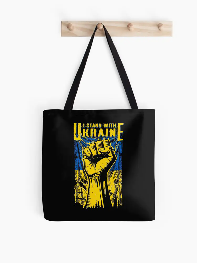 An eco-friendly black tote bag printed with the 'I STAND WITH UKRAINE' manifesto, ideal for activists who prioritize sustainable shopping and public advocacy.