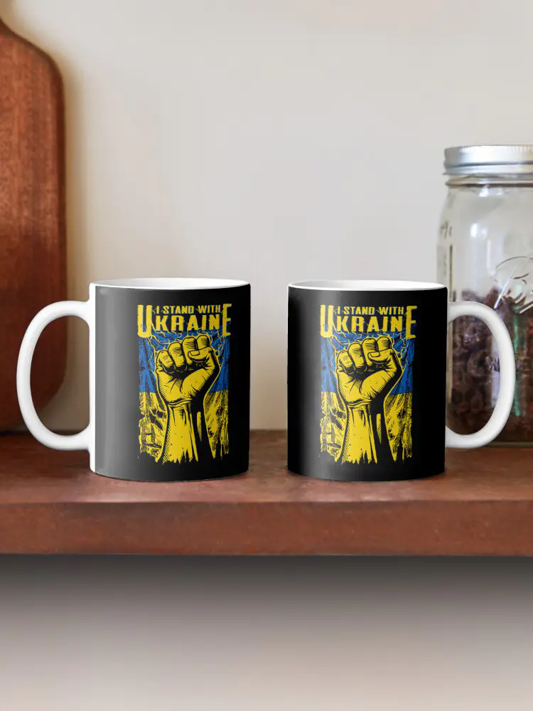 Two black ceramic mugs featuring the 'I STAND WITH UKRAINE' design, suitable for office environments or home settings to display consistent, daily support for human rights.