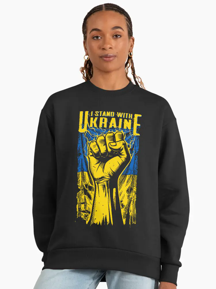 A high-quality black crewneck sweatshirt featuring a bold yellow and blue 'I STAND WITH UKRAINE' design with a clenched fist symbol, representing modern political activism and solidarity.